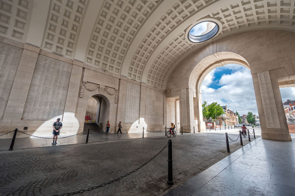 Cyclists and pedestrians passing through the central barrel vault of the Ypres (Menin Gate) Memorial. 