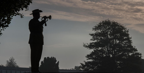 A silhouette of a bugler