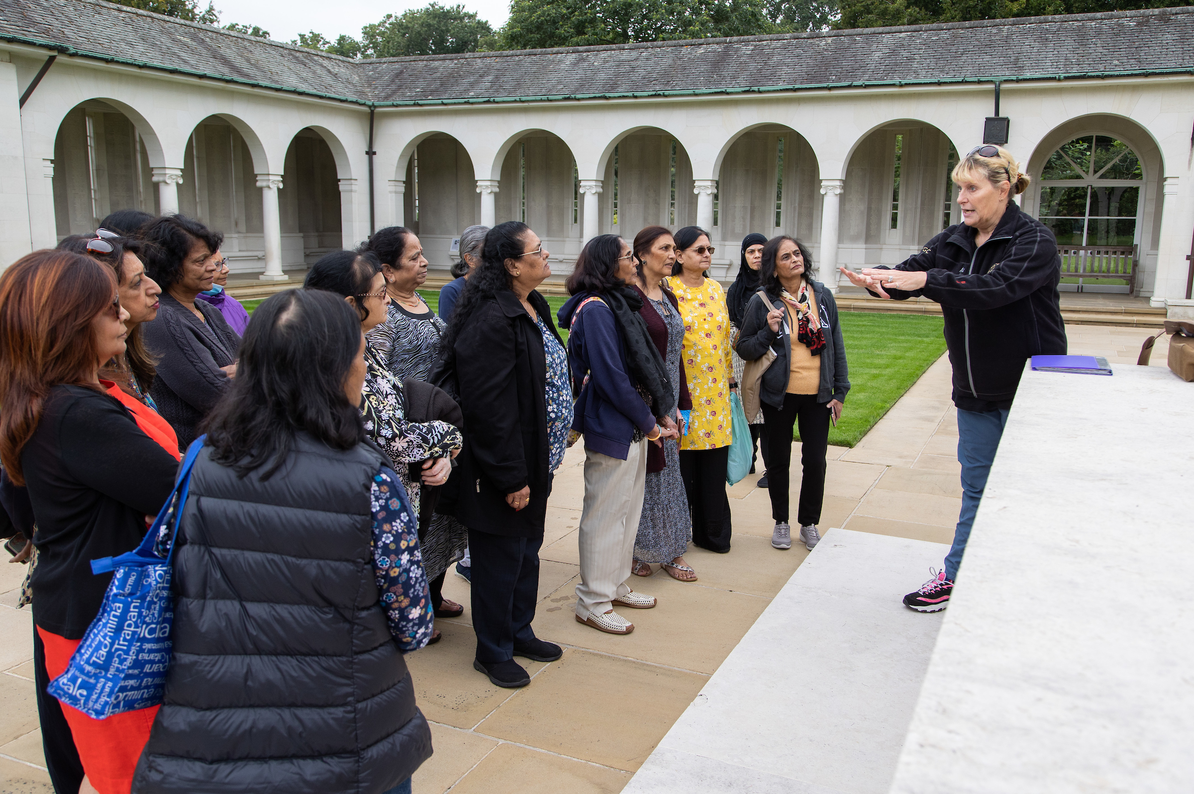 Tour guide speaking to a group of tourgoers at Runnymede Memorial